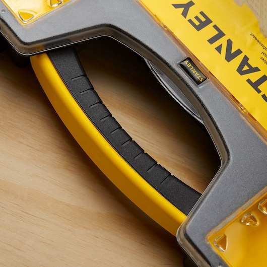 STANLEY 014725R yellow and black handle detail, close-up photography of tool box on wood surface.