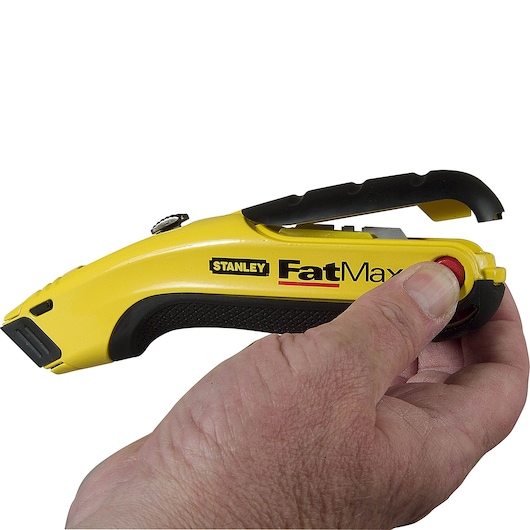 Photo of STANLEY 10-778 utility knife with yellow and black grip, held in hand, brand logo visible, side angle.