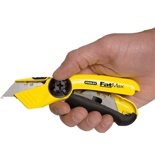 Photo of STANLEY 10-780 utility knife, yellow and black, held in hand, blade extended, product close-up.