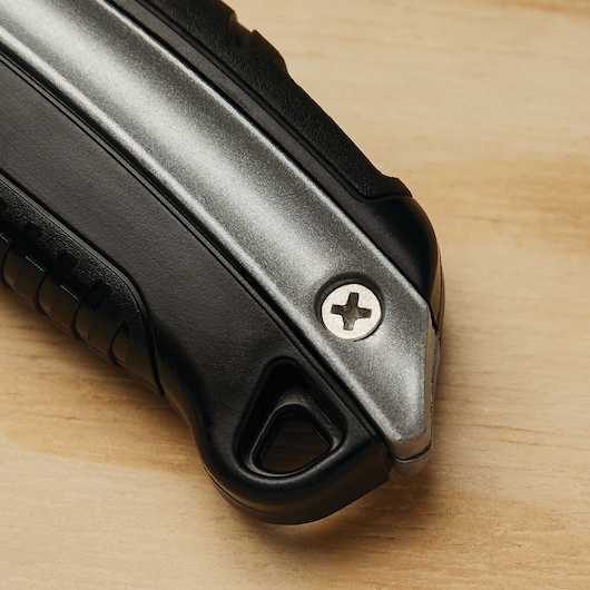 Close-up photo of STANLEY 10-788 utility knife handle with black and silver detail on wood surface.