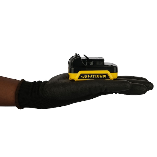 STANLEY SB12S 12V lithium battery resting on a gloved hand, side view, with black and yellow casing.