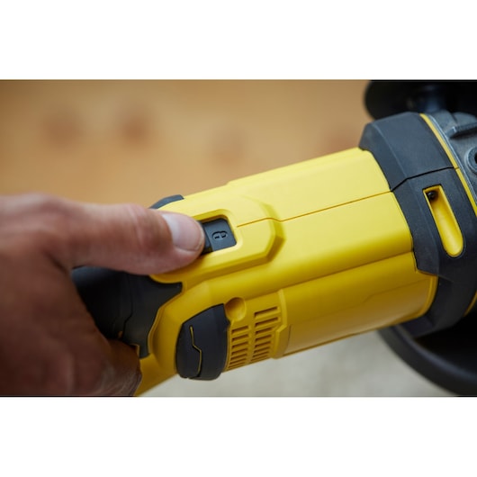 Photo of STANLEY SCG400M2K-KR angle grinder close-up showing power switch and yellow-black casing.