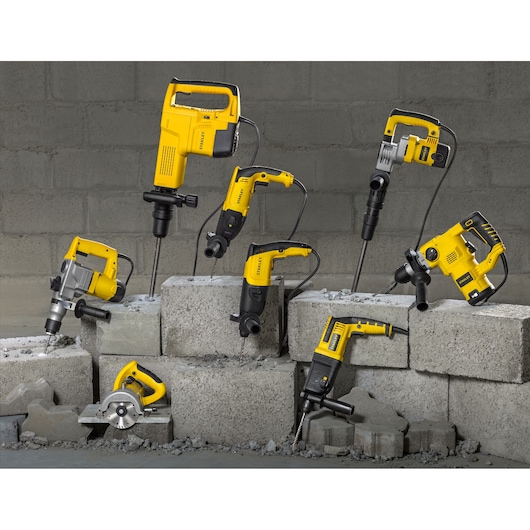 STANLEY SHR263K-BR corded power tools displayed on concrete blocks, front angle, yellow and black design.