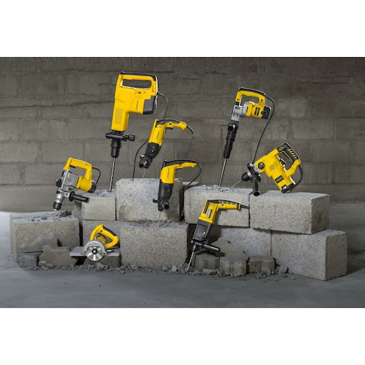 STANLEY SHR263K-BR rotary hammers and drills displayed on concrete blocks, front angle.