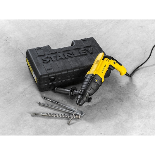 Stanley SHR263K-BR corded rotary hammer with drill bits and black carrying case on concrete.