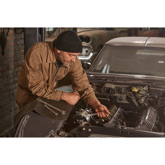 STANLEY STMT72834 wrenches on car hood, mechanic working on engine, garage setting, angled photography