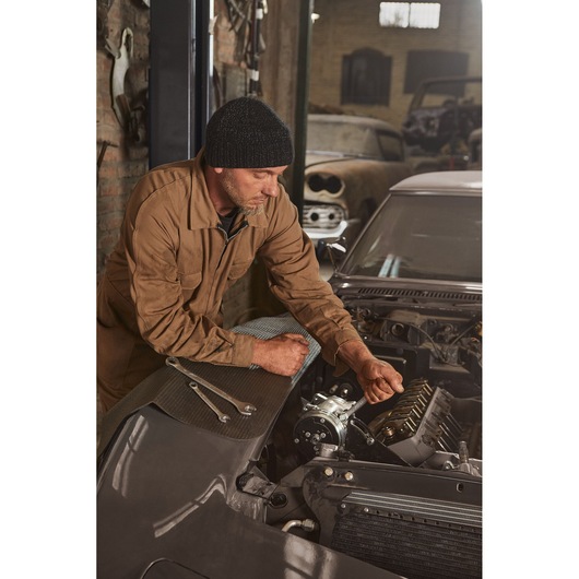 STANLEY STMT72834 wrench photography, mechanic using wrench on car engine in workshop, angled view.