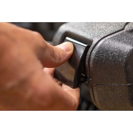 STANLEY STMT82828-LA photography, close-up of hand pressing black latch on textured plastic case.