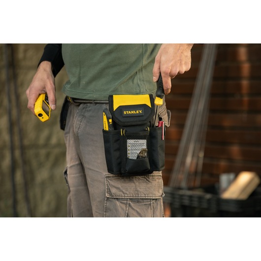 Photo of STANLEY STST509104LA tool pouch on belt with tools, shown in use outdoors.